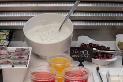 a counter with a bowl of yogurt and other ingredients at Hotel Hermes in Rhodes Town