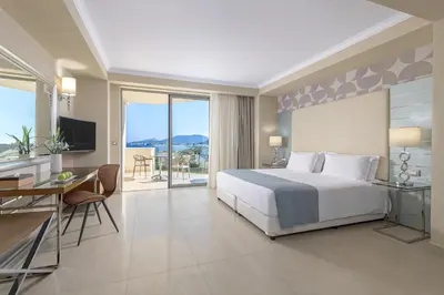 a bedroom with a bed and a desk and a television at Atrium Platinum Resort & Spa in Ixia