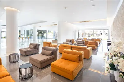 a lobby with couches and chairs and flowers at Doreta Beach in Theologos