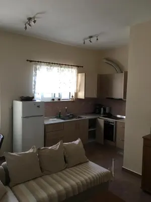 a living room with a couch in a kitchen at Matrel Home in Rhodes Town