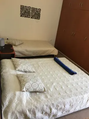 two twin beds in a room with a bedmitt at Matrel Home in Rhodes Town