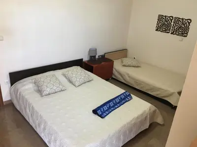 a bedroom with two beds and a dresser and a bed sidx sidx at Matrel Home in Rhodes Town