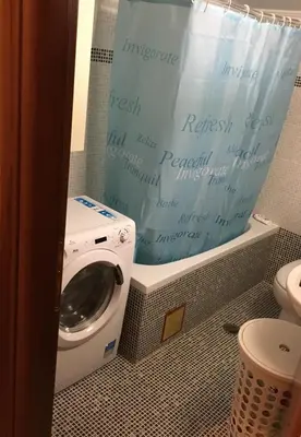 a washing machine in a bathroom with a shower curtain at Matrel Home in Rhodes Town
