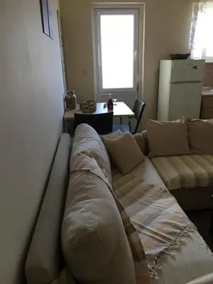 a large couch in a living room with a table at Matrel Home in Rhodes Town