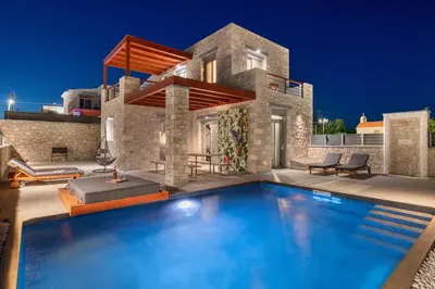 a swimming pool in front of a house at Southrock Villas in Lachania