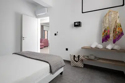a bedroom with a bed and a painting on the wall at Southrock Villas in Lachania