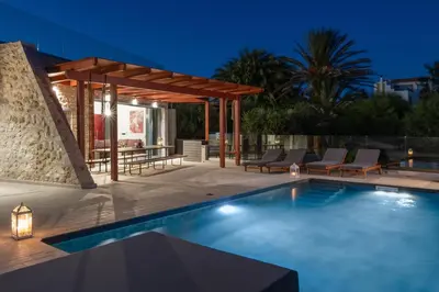 a swimming pool with a gazebo and a patio at Southrock Villas in Lachania