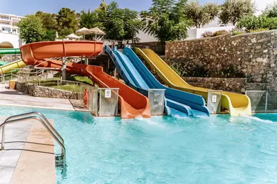 a water slide in a pool at a resort at Lindos Royal Resort in Líndos