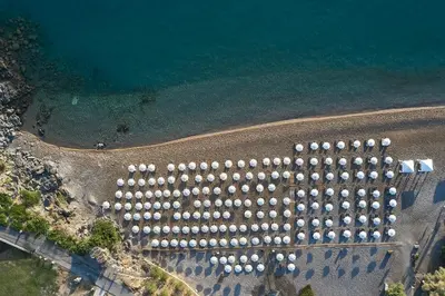 an overhead view of a row of umbrellas on a beach at Lindos Royal Resort in Líndos