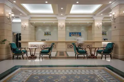 a lobby with chairs and a table and a bar at Lindos Imperial Resort & Spa in Kiotari