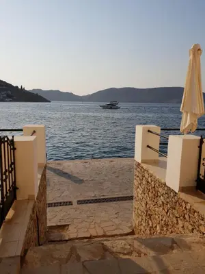 a view of the water with an umbrella at Sea Stars ,Villas Danezis in Symi
