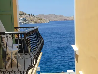 a balcony with a view of a body of water at Sea Stars ,Villas Danezis in Symi