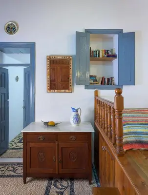 a bedroom with a wooden dresser with a vase on it at Erato Apartments in Líndos