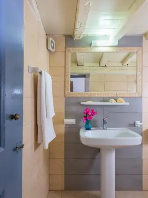 a bathroom with a sink and a mirror at Erato Apartments in Líndos