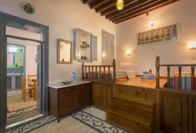 a room with a bedroom with a bed and a doorway at Erato Apartments in Líndos