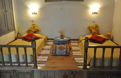a room with two beds and a table in it at Erato Apartments in Líndos