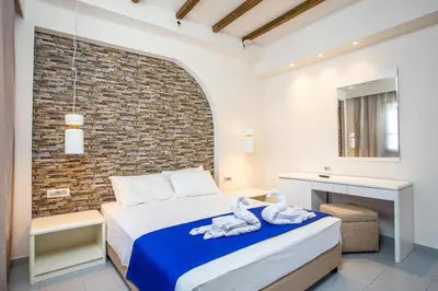 a bedroom with a bed and a brick wall at Christina Dream Village in Pastida