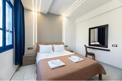 a bedroom with a bed with two towels on it at Christina Dream Village in Pastida