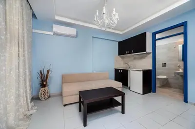 a living room with a couch and a table at Christina Dream Village in Pastida