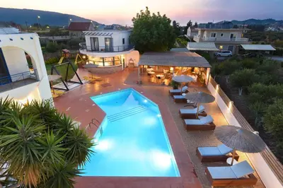 an overhead view of a swimming pool with chairs and umbrellas at Christina Dream Village in Pastida