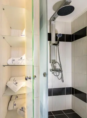 a shower in a bathroom with a glass door at Rhodes Central Suite in Rhodes Town