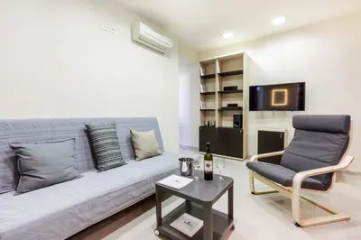 a living room with a couch and a chair at Rhodes Central Suite in Rhodes Town