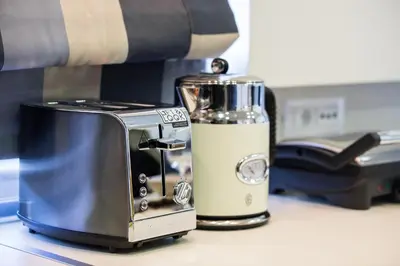 a blender sitting on a counter next to a toaster at Rhodes Central Suite in Rhodes Town