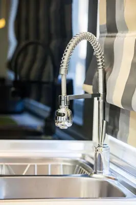 a kitchen sink with a chrome kitchen faucet at Rhodes Central Suite in Rhodes Town