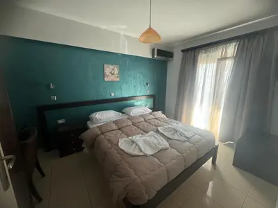 a bedroom with a bed with two towels on it at Comfort Hotel Apartments in Rhodes Town