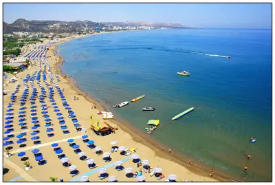 an aerial view of a beach with umbrellas and boats at Saint Amon Hotel in Faliraki