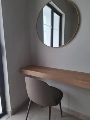 a mirror on a wall with a chair under it at Hotel Platon in Faliraki