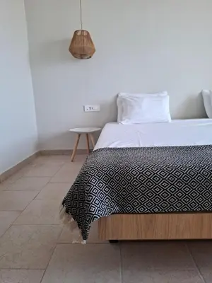 a bedroom with a bed with a black and white comforter at Hotel Platon in Faliraki