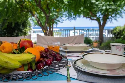 a table with plates of fruit on top of it at Casa Elizabeta in Archangelos