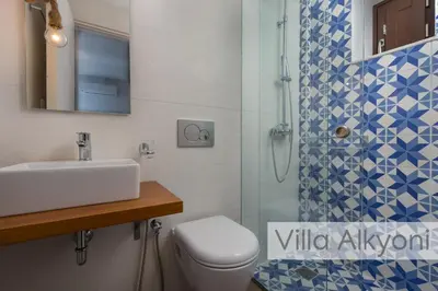 a bathroom with a toilet and a sink and a shower at Lindos Amphitheater Villas and Apartments in Líndos