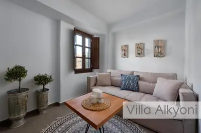 a living room with a couch and a table at Lindos Amphitheater Villas and Apartments in Líndos