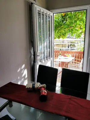 a dining room table with two chairs and a sliding glass door at Amazing apartment 100 meters from the Old Town in Rhodes Town