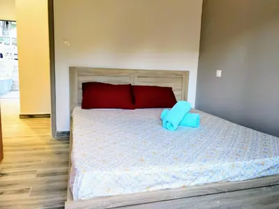 a bedroom with a bed with a blue pillow on it at Amazing apartment 100 meters from the Old Town in Rhodes Town