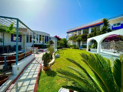 a courtyard of a building with a yard with plants at SCALA APARTS & STUDIOS - Rhodes in Afantou