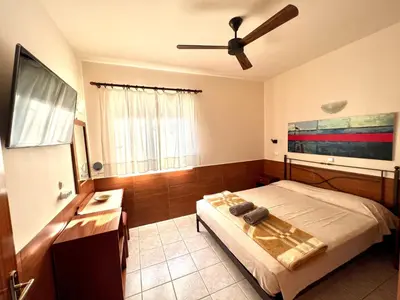 a bedroom with a bed and a ceiling fan at SCALA APARTS & STUDIOS - Rhodes in Afantou