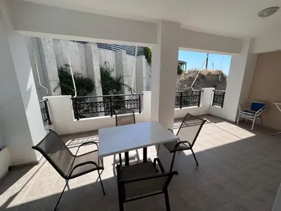 a room with a table and chairs on a balcony at SCALA APARTS & STUDIOS - Rhodes in Afantou