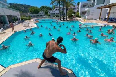 a group of people swimming in a swimming pool at Avra Beach Resort in Ixia