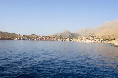 a large body of water with houses and buildings at Kleanthe in Halki