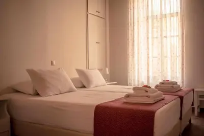 a bedroom with a bed with two towels on it at Kleanthe in Halki