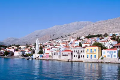 a group of houses on the shore of a body of water at Kleanthe in Halki