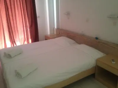 a bedroom with a bed with two towels on it at Blue Roses in Ixia