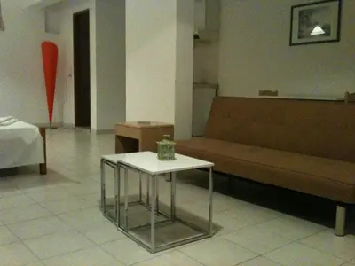 a living room with a couch and a table at Blue Roses in Ixia