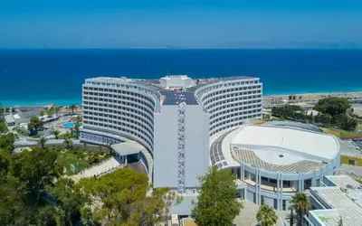 a large white building next to the ocean at Akti Imperial Deluxe Resort & Spa Dolce by Wyndham in Ixia