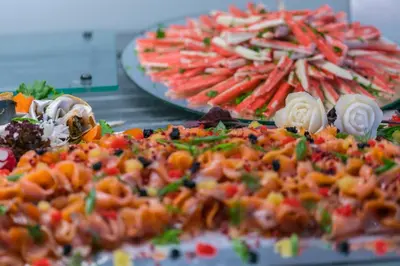 a bunch of different types of food on plates at Akti Imperial Deluxe Resort & Spa Dolce by Wyndham in Ixia