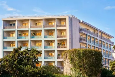 an apartment building with its lights on at AQUAMARE CITY and BEACH in Rhodes Town