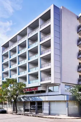 an apartment building with a parking garage at AQUAMARE CITY and BEACH in Rhodes Town